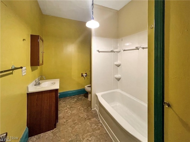 bathroom featuring baseboard heating, toilet, vanity, shower / tub combination, and baseboards