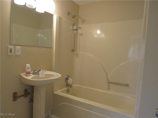 bathroom featuring shower / washtub combination and a sink