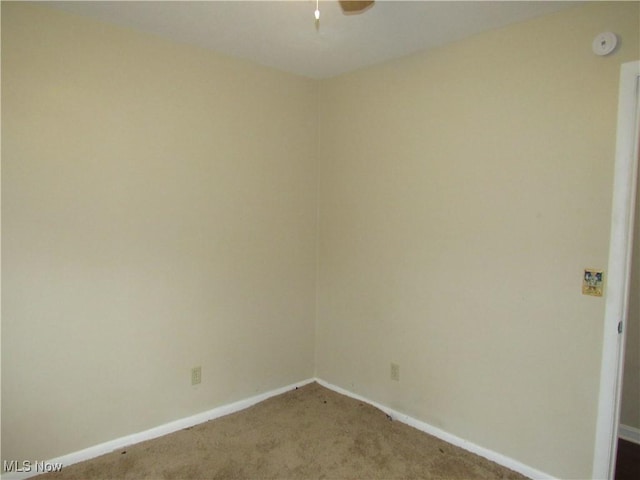 spare room featuring carpet floors, baseboards, and a ceiling fan