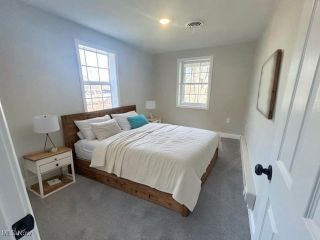 bedroom with multiple windows, carpet, visible vents, and baseboards