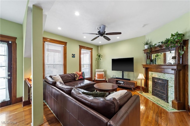 living area with a fireplace, a ceiling fan, wood finished floors, and recessed lighting