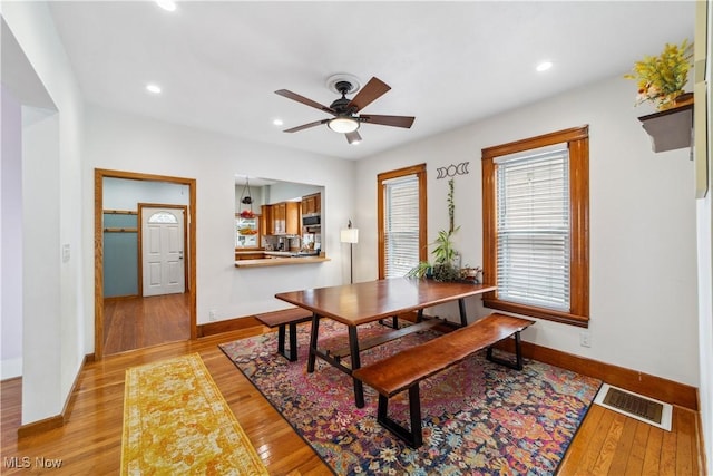 dining space featuring recessed lighting, a ceiling fan, baseboards, visible vents, and light wood-style floors