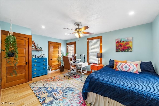 bedroom with light wood-type flooring and ceiling fan