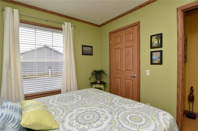 5655 E Windjamer Ave, Lakeside-Marblehead, OH 43440 - bedroom featuring ornamental molding