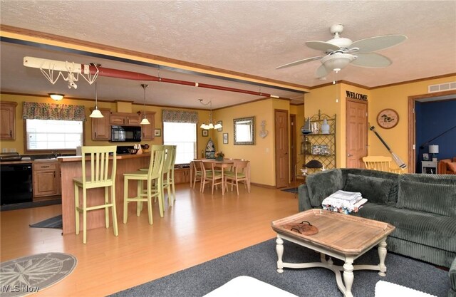 5655 E Windjamer Ave, Lakeside-Marblehead, OH 43440 - living area with visible vents, crown molding, a textured ceiling, and wood finished floors