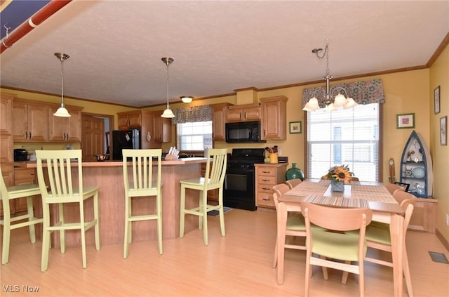 5655 E Windjamer Ave, Lakeside-Marblehead, OH 43440 - dining area with ornamental molding, light wood-type flooring, visible vents, and an inviting chandelier