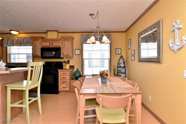 5655 E Windjamer Ave, Lakeside-Marblehead, OH 43440 - dining space featuring a textured ceiling, ornamental molding, light wood-style flooring, and a notable chandelier