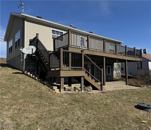 rear view of property featuring stairs, a yard, and a wooden deck