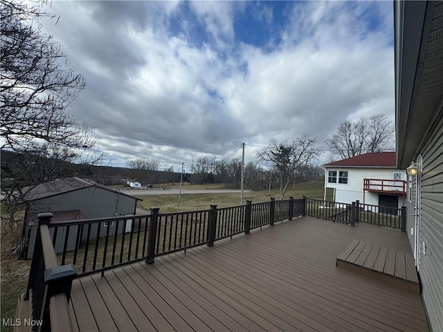 wooden terrace featuring a yard