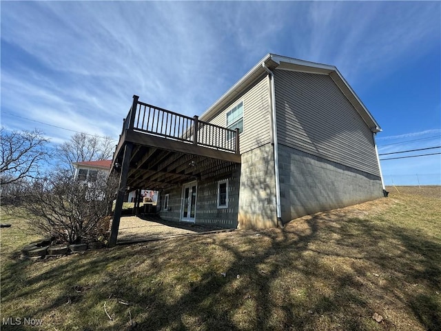 view of property exterior with a wooden deck