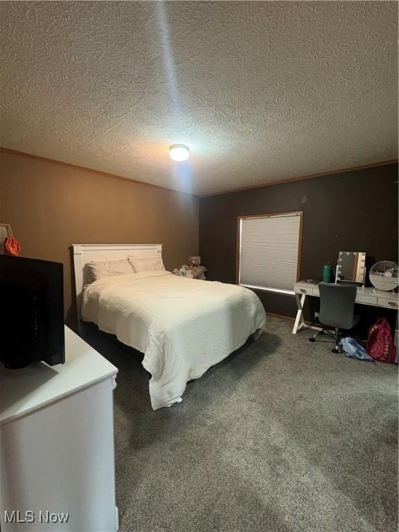 carpeted bedroom featuring a textured ceiling