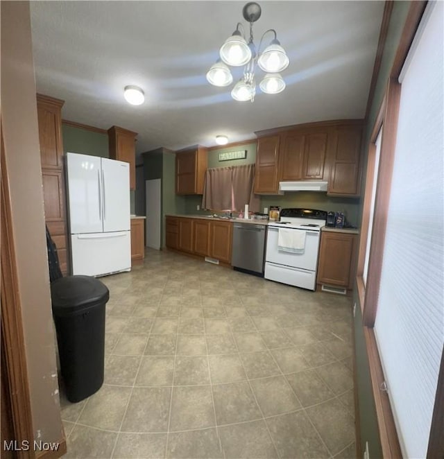 kitchen with brown cabinets, white appliances, light countertops, and under cabinet range hood