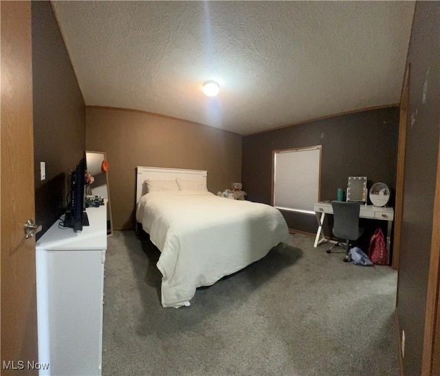 carpeted bedroom featuring a textured ceiling