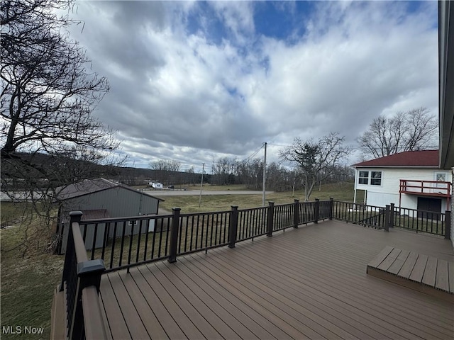 wooden terrace with a yard