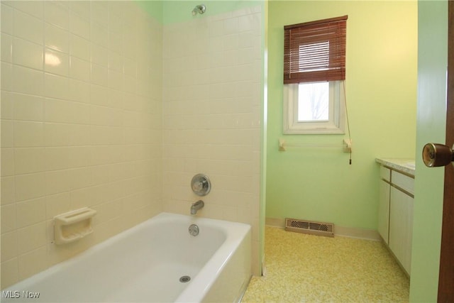 full bathroom with shower / bathtub combination, vanity, visible vents, and baseboards