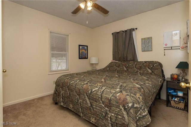 bedroom with carpet floors, baseboards, and a ceiling fan