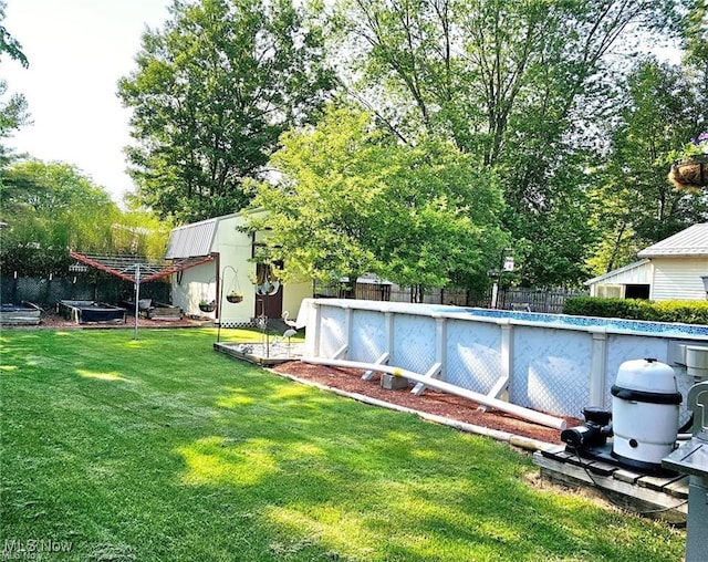 view of yard featuring fence and an outdoor pool