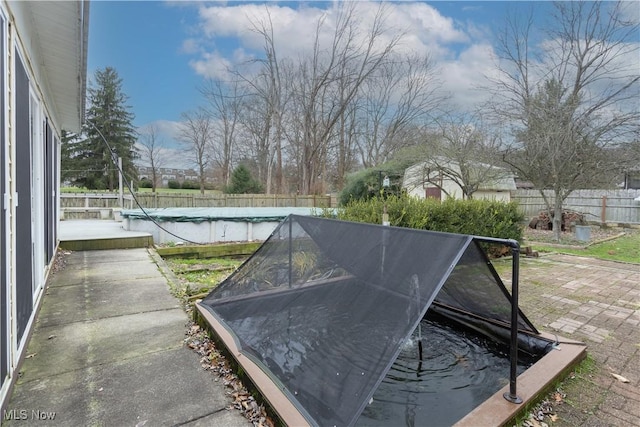 exterior space featuring fence and a pool