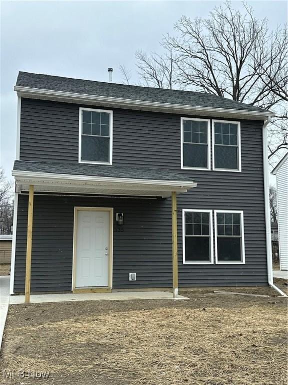 back of property with a porch