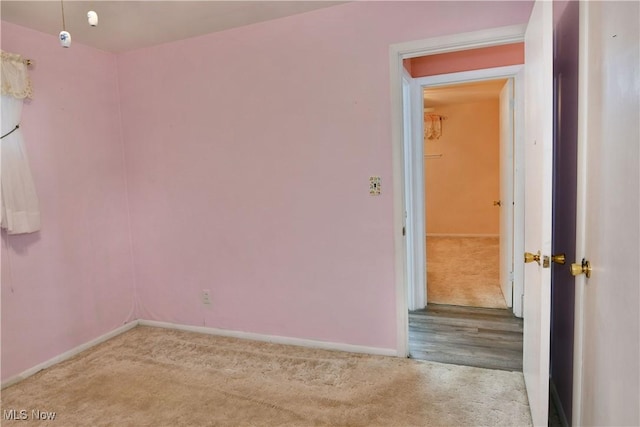 empty room with carpet floors and baseboards