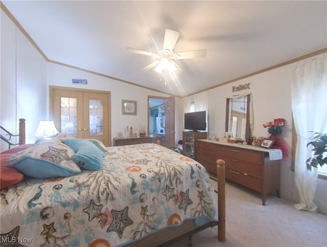 bedroom with lofted ceiling, ornamental molding, french doors, and light colored carpet