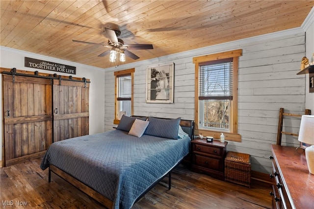 bedroom featuring ornamental molding, a barn door, wooden ceiling, and wood finished floors