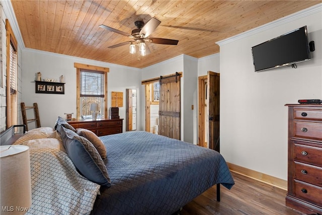 bedroom featuring ornamental molding, wood finished floors, wood ceiling, and a barn door