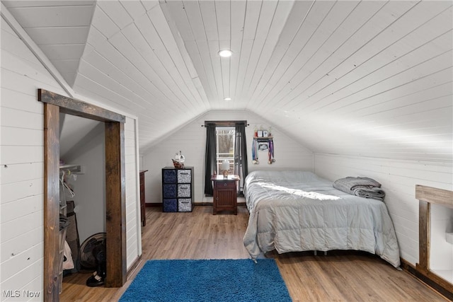 bedroom with wooden ceiling, vaulted ceiling, and wood finished floors