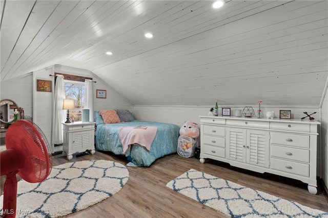 bedroom featuring wooden walls, wood ceiling, wood finished floors, vaulted ceiling, and recessed lighting