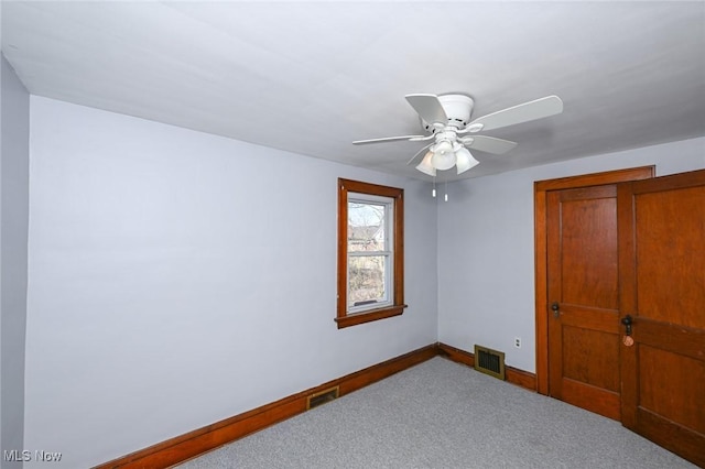 bedroom with carpet flooring, visible vents, ceiling fan, and baseboards