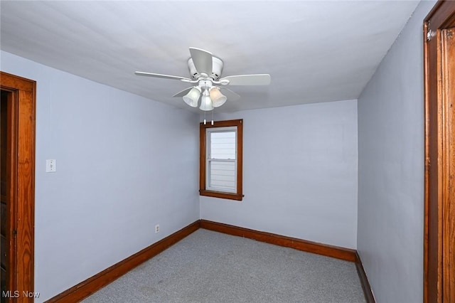 spare room featuring baseboards, a ceiling fan, and carpet flooring