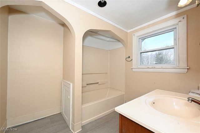 full bathroom featuring ornamental molding, vanity, and baseboards