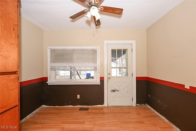 empty room with ceiling fan, visible vents, and light wood-style floors