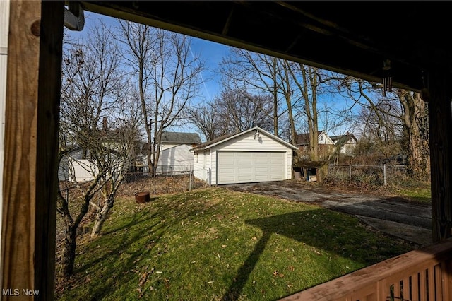 view of yard with an outbuilding, a fenced backyard, and a garage