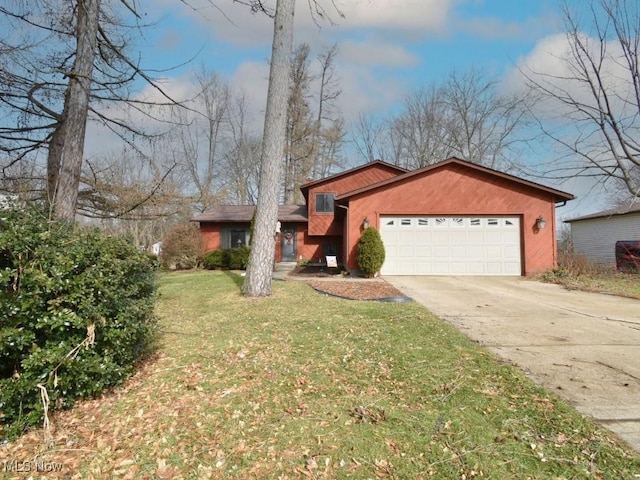 view of front of house with concrete driveway, a front lawn, and an attached garage