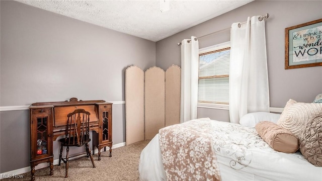 carpeted bedroom with baseboards and a textured ceiling