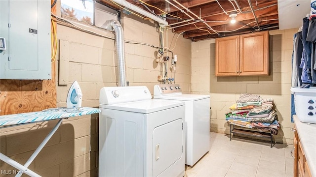 laundry area with washing machine and dryer, electric panel, and cabinet space