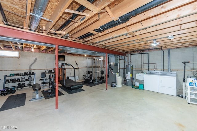 unfinished below grade area featuring water heater, independent washer and dryer, and a sink