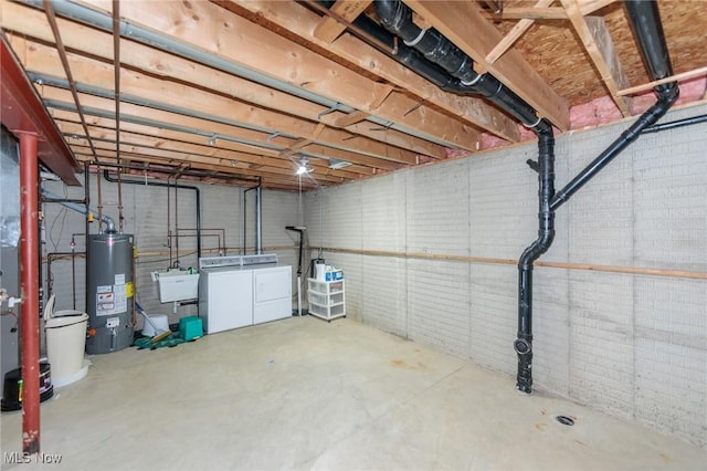 unfinished basement featuring a sink, washer and dryer, and gas water heater