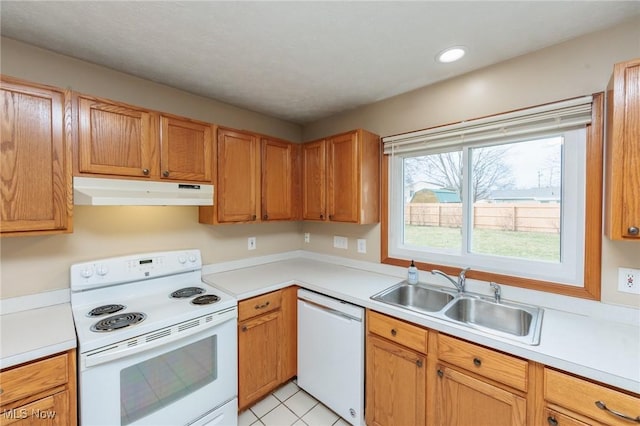 kitchen with recessed lighting, light countertops, a sink, white appliances, and under cabinet range hood