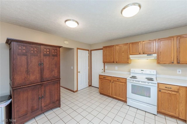 kitchen with a textured ceiling, under cabinet range hood, electric range, baseboards, and light countertops