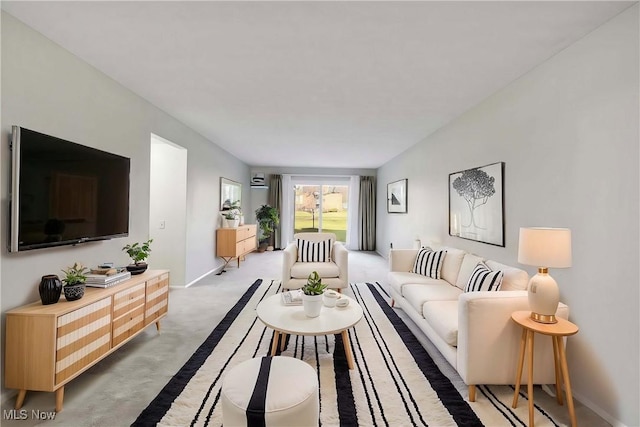 carpeted living area with baseboards