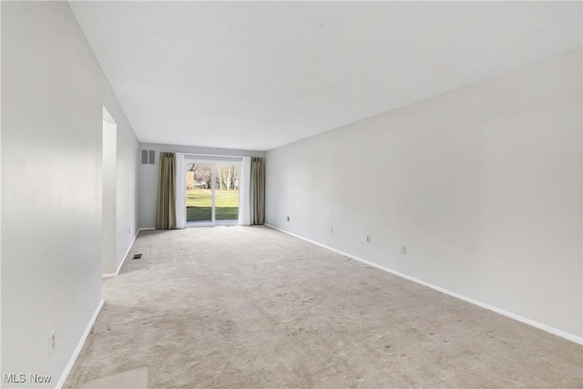 carpeted empty room with baseboards and visible vents