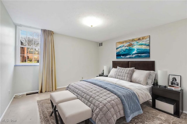 carpeted bedroom featuring baseboards and visible vents