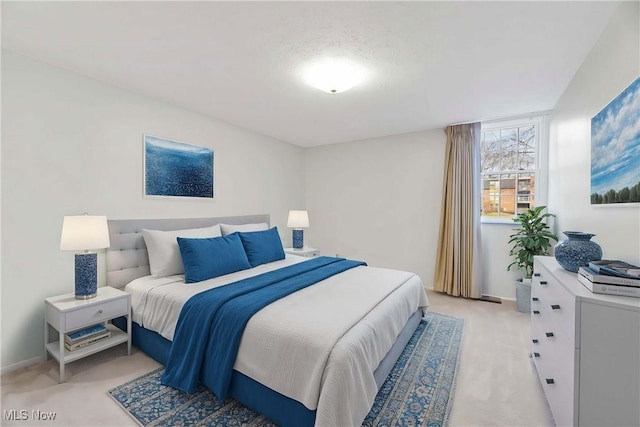 bedroom featuring light colored carpet