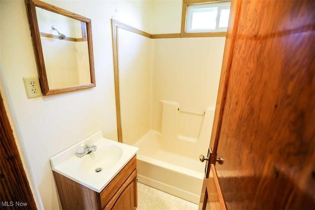 bathroom featuring tub / shower combination and vanity