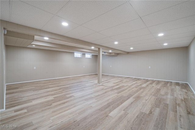 below grade area featuring recessed lighting, wood finished floors, and baseboards