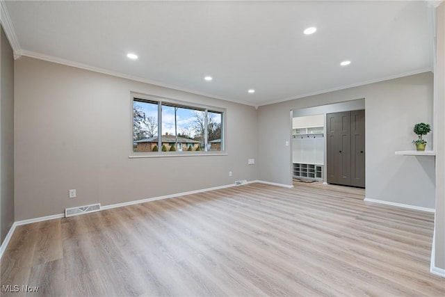 interior space with crown molding, visible vents, and baseboards