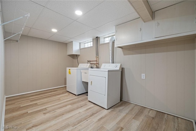 laundry room featuring light wood-type flooring, washer and dryer, cabinet space, and recessed lighting