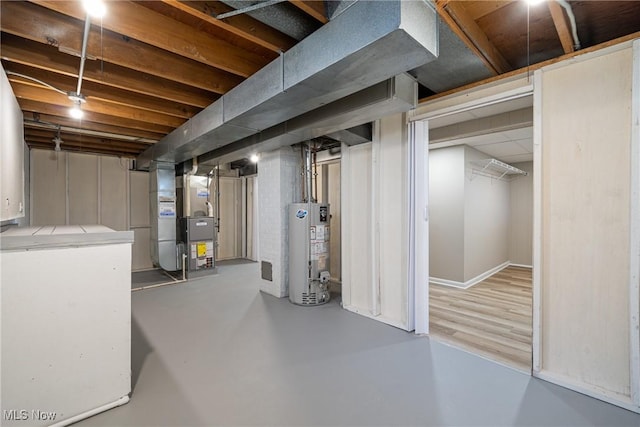 unfinished basement with heating unit and gas water heater